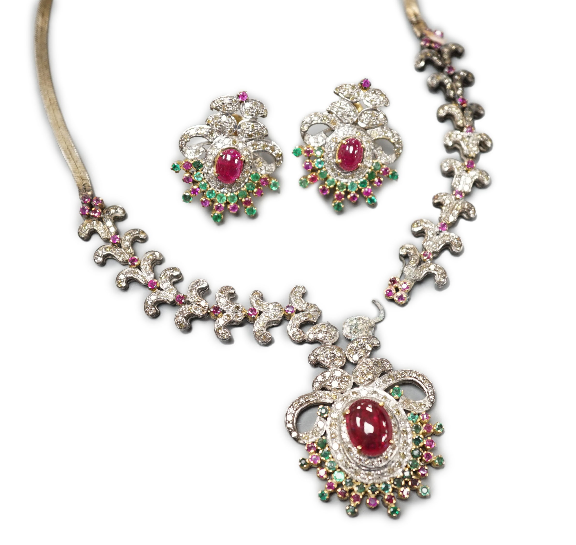 An Indian white and yellow metal, diamond, ruby and gem set necklace, 46cm and pair of matching earrings.
